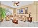 Bright living room with comfortable seating, tile flooring, and large windows allowing for ample sunlight at 2632 Emerald Island Blvd, Kissimmee, FL 34747
