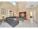 Living room with comfortable sectional, entertainment center, and backyard view at 2632 Emerald Island Blvd, Kissimmee, FL 34747