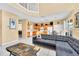 Open-concept living area with a gray sectional and views of the kitchen at 2632 Emerald Island Blvd, Kissimmee, FL 34747