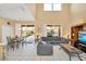 Open concept living room with high ceilings, tile flooring, gray sofa, and sliding doors to the pool at 2632 Emerald Island Blvd, Kissimmee, FL 34747