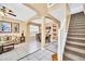 Open concept living room with staircase, view to dining area, and lots of natural light at 2632 Emerald Island Blvd, Kissimmee, FL 34747