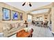 Open concept living and dining room area with comfortable seating and stylish decor at 2632 Emerald Island Blvd, Kissimmee, FL 34747