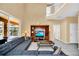 Open-concept living room with a large sofa, TV, and access to the patio at 2632 Emerald Island Blvd, Kissimmee, FL 34747