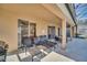 Covered patio with seating and a grill perfect for entertaining or relaxing outdoors at 2632 Emerald Island Blvd, Kissimmee, FL 34747