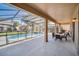 Enjoy this beautiful covered patio, with plenty of room to grill and entertain overlooking the pool at 2632 Emerald Island Blvd, Kissimmee, FL 34747