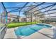 Enjoy the beautiful screened-in pool and spa and your lush green yard with privacy at 2632 Emerald Island Blvd, Kissimmee, FL 34747