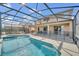 A stunning screened-in pool with safety fence is perfect for relaxing and entertaining outdoors at 2632 Emerald Island Blvd, Kissimmee, FL 34747