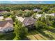 Aerial view of a home with a screened in lanai and lush backyard that backs up to conservation at 2746 Kissimmee Bay Cir, Kissimmee, FL 34744