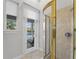 Modern bathroom featuring glass shower, neutral tile, and access to the outdoor area at 2746 Kissimmee Bay Cir, Kissimmee, FL 34744