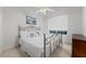Bright bedroom with a window, a ceiling fan, and a metal framed bed with white linens at 2746 Kissimmee Bay Cir, Kissimmee, FL 34744