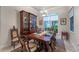 Formal dining room with elegant table setting, china cabinet, and bright window view at 2746 Kissimmee Bay Cir, Kissimmee, FL 34744