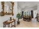 Elegant foyer with ornate mirror, decorative table, and view into the sunlit living room at 2746 Kissimmee Bay Cir, Kissimmee, FL 34744