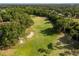 Scenic view of lush golf course with mature trees and well-maintained fairways at 2746 Kissimmee Bay Cir, Kissimmee, FL 34744