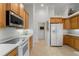 Well-lit kitchen with a microwave and smooth top stove and white refrigerator at 2746 Kissimmee Bay Cir, Kissimmee, FL 34744