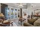 Cozy living room featuring elegant furniture, French doors to the lanai, and neutral tile flooring at 2746 Kissimmee Bay Cir, Kissimmee, FL 34744