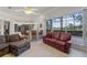 Bright living room featuring large windows and comfortable seating and wet bar at 2746 Kissimmee Bay Cir, Kissimmee, FL 34744