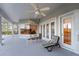 Covered patio with ceiling fans, outdoor seating, and views of mature trees and the pool at 2746 Kissimmee Bay Cir, Kissimmee, FL 34744
