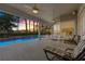 Beautiful screened-in pool area at twilight with a covered patio and ample seating at 2746 Kissimmee Bay Cir, Kissimmee, FL 34744