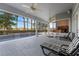 Screened-in pool area with a covered patio, ceiling fans, and a view of mature trees at 2746 Kissimmee Bay Cir, Kissimmee, FL 34744
