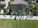 Aerial view of backyard featuring a screened-in pool area with lush tropical landscaping and privacy fence at 2888 Spring Breeze Way, Kissimmee, FL 34744