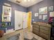 Charming bedroom featuring blue walls, fun wall decor, and a lovely rug with stylish furnishings at 2888 Spring Breeze Way, Kissimmee, FL 34744