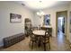 Cozy dining area features a round table, four chairs, decorative mirror, and a gray upholstered bench at 2888 Spring Breeze Way, Kissimmee, FL 34744