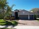 Charming single-Gathering home with brick driveway, well-maintained landscaping, and three-car garage at 2888 Spring Breeze Way, Kissimmee, FL 34744