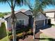 Charming home featuring a well-maintained front yard with landscaping, a two-car garage, and a neutral-toned exterior at 2888 Spring Breeze Way, Kissimmee, FL 34744