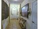 Inviting foyer with tiled floor, decorative artwork, and a view of the front door at 2888 Spring Breeze Way, Kissimmee, FL 34744