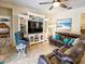 Comfortable living room featuring a large leather sectional and entertainment center with built-in shelving at 2888 Spring Breeze Way, Kissimmee, FL 34744