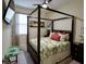 Comfortable bedroom with four-poster bed, tropical decor, ceiling fan, and natural light at 2888 Spring Breeze Way, Kissimmee, FL 34744