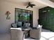 Covered patio with stylish outdoor furniture, ceiling fan, and a view of the sparkling screened-in pool at 2888 Spring Breeze Way, Kissimmee, FL 34744