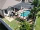 Aerial view of screened-in pool area offering an inviting outdoor living space and palm trees at 2888 Spring Breeze Way, Kissimmee, FL 34744