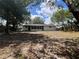 View of the back of the home with a large yard and screened in patio at 3045 Plaza Terrace Dr, Orlando, FL 32803