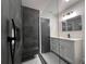 Modern bathroom with walk-in shower, gray tile, a built-in bench, and a stylish vanity at 3045 Plaza Terrace Dr, Orlando, FL 32803