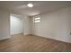 Minimalist bedroom featuring hardwood flooring, white walls, and natural light at 3045 Plaza Terrace Dr, Orlando, FL 32803
