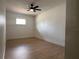 Bright bedroom featuring wood-look flooring, a ceiling fan, and a window at 3045 Plaza Terrace Dr, Orlando, FL 32803