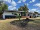 Landscaped front yard and painted home exterior with a modern design on a sunny day at 3045 Plaza Terrace Dr, Orlando, FL 32803