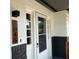 Charming front door with glass features and a modern black light fixture beside the address at 3045 Plaza Terrace Dr, Orlando, FL 32803