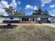 Well-maintained home exterior with lawn and flower beds on a beautiful, sunny day at 3045 Plaza Terrace Dr, Orlando, FL 32803