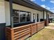 Inviting front porch with a charming wood fence and white and black painted exterior at 3045 Plaza Terrace Dr, Orlando, FL 32803