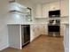 Bright kitchen with white cabinets, stainless steel appliances, and wood-look flooring at 3045 Plaza Terrace Dr, Orlando, FL 32803