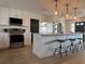 Bright kitchen boasts white cabinets, stainless steel appliances, and a large island with pendant lighting at 3045 Plaza Terrace Dr, Orlando, FL 32803