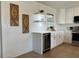 Modern kitchen with white cabinets, stainless steel appliances, and a built-in wine cooler at 3045 Plaza Terrace Dr, Orlando, FL 32803