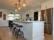 Bright kitchen boasts white cabinets, stainless steel appliances, and a large island with pendant lighting at 3045 Plaza Terrace Dr, Orlando, FL 32803