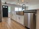Stylish kitchen with stainless steel dishwasher, apron sink, and modern fixtures at 3045 Plaza Terrace Dr, Orlando, FL 32803