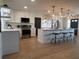 Bright kitchen boasts white cabinets, stainless steel appliances, and a large island with pendant lighting at 3045 Plaza Terrace Dr, Orlando, FL 32803
