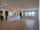 Open-concept living space with wood floors, large windows, and a modern kitchen with an island at 3045 Plaza Terrace Dr, Orlando, FL 32803