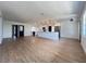 Expansive living room with wood floors, an open kitchen, stainless steel appliances, and a large island at 3045 Plaza Terrace Dr, Orlando, FL 32803