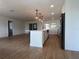 Spacious living room with wood floors, an open kitchen, a large island, and stainless steel appliances at 3045 Plaza Terrace Dr, Orlando, FL 32803